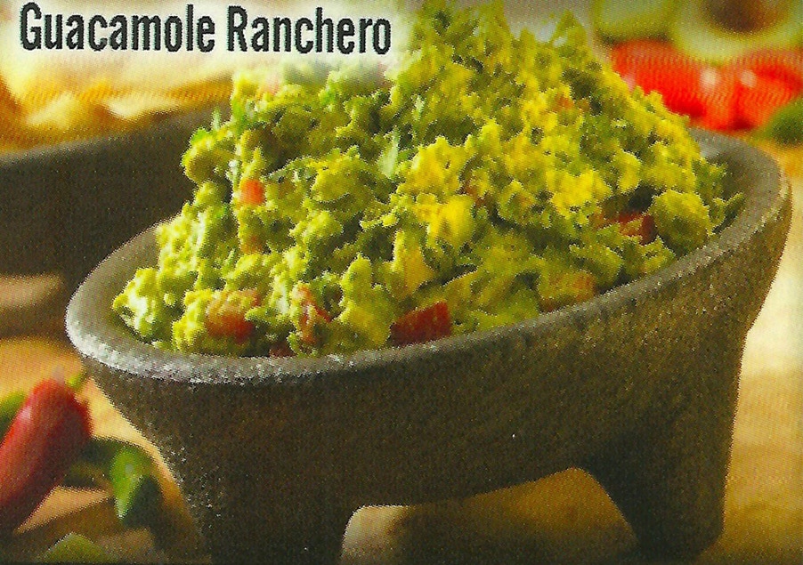 Bustling outdoor market scene with people wearing masks and colorful stalls.